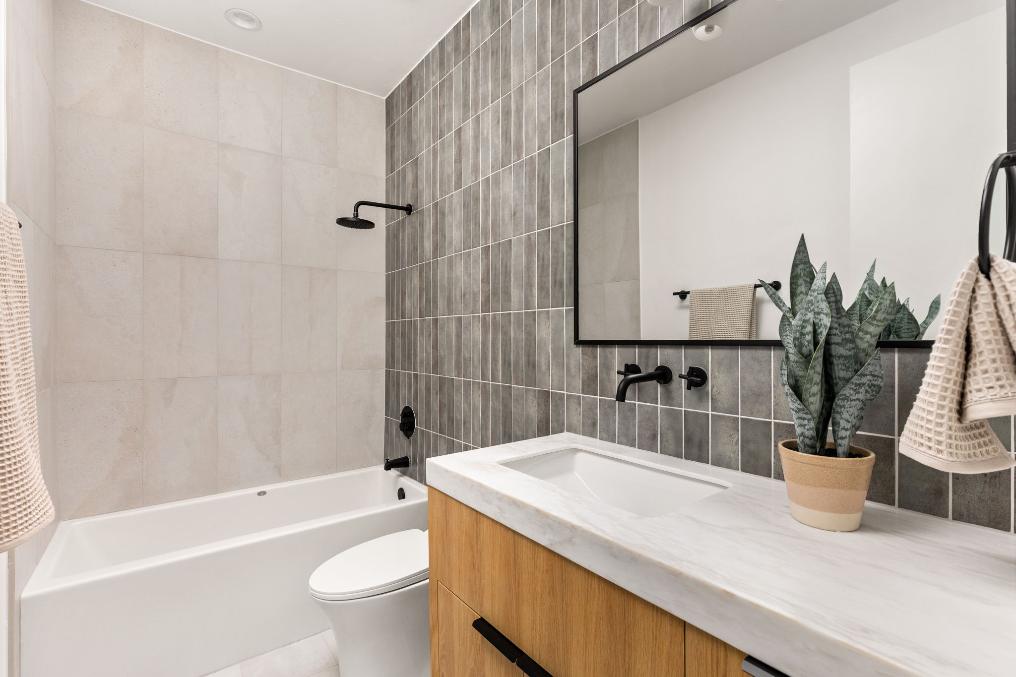 1610 Harvey Street, Unit 2 Austin, TX 78702 - Photo 22 of 38 Full bathroom with tile walls, vanity, shower / bath combination with curtain, and backsplash