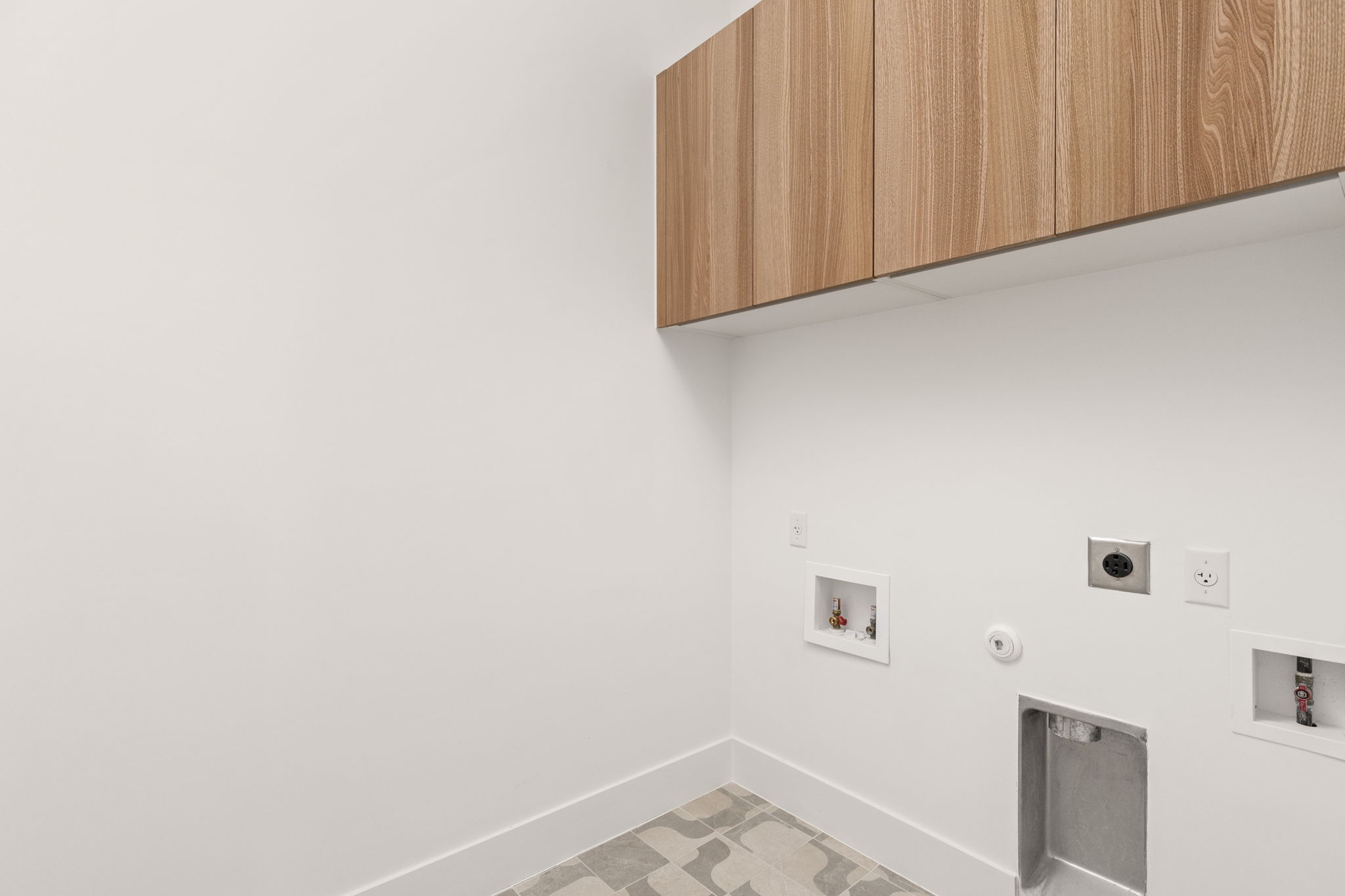 1610 Harvey Street, Unit 2 Austin, TX 78702 - Photo 24 of 38 Laundry area with washer hookup, gas dryer hookup, cabinet space, and electric dryer hookup