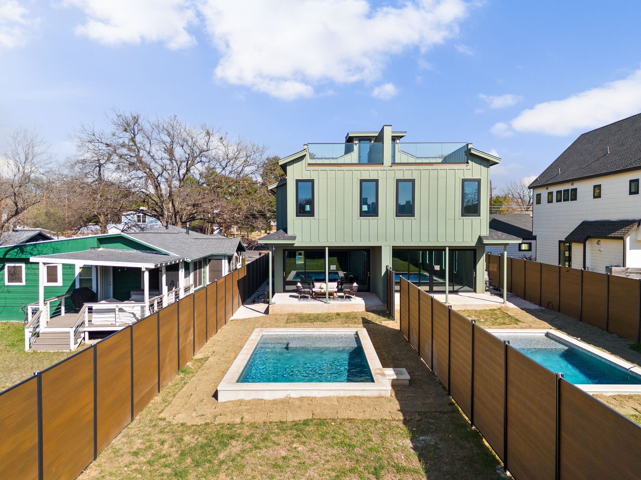1610 Harvey Street, Unit 2 Austin, TX 78702 - Photo 34 of 38 Back of house featuring board and batten siding, a patio, and a fenced backyard