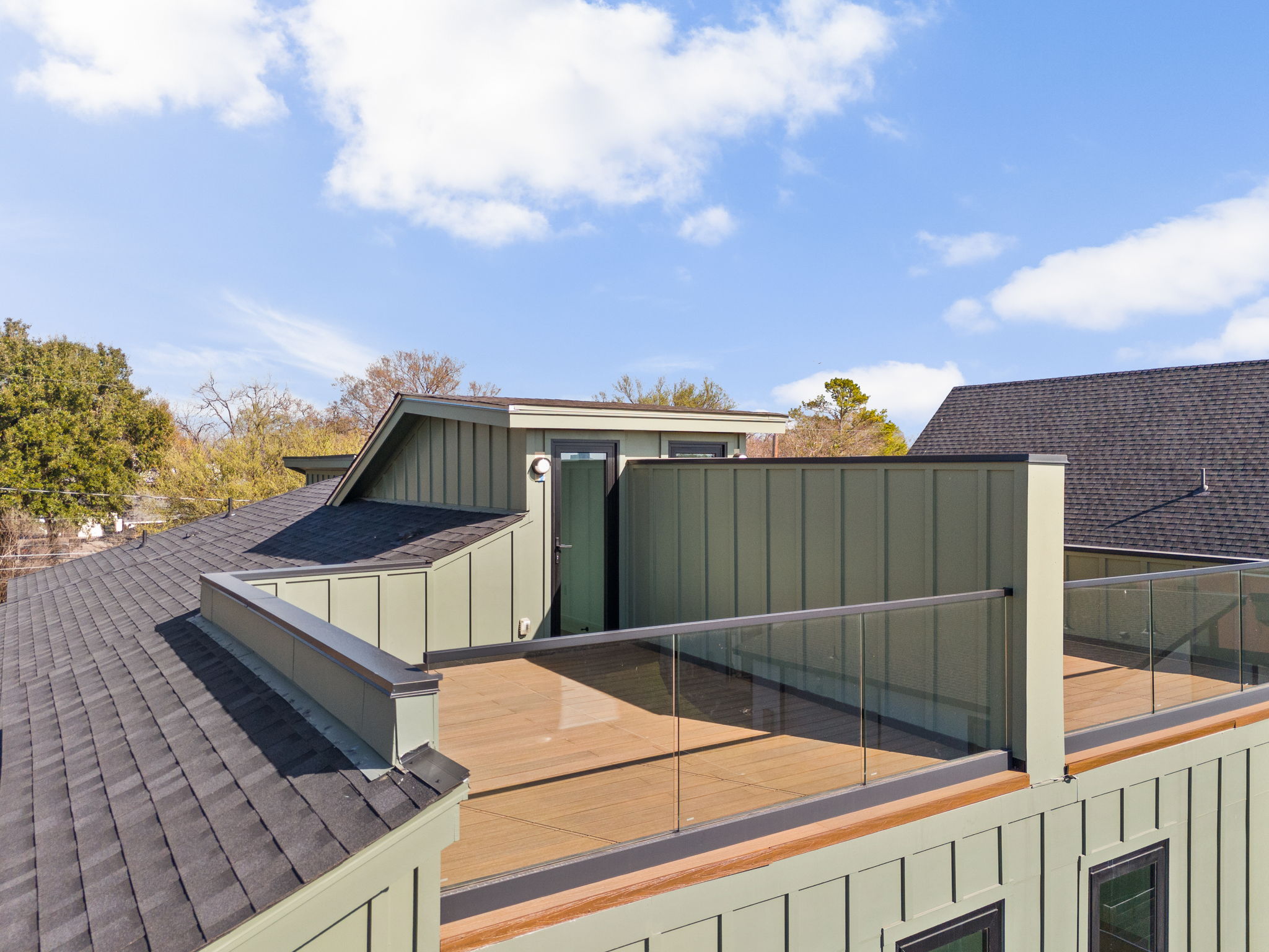 1610 Harvey Street, Unit 2 Austin, TX 78702 - Photo 35 of 38 View of home's exterior with board and batten siding and a shingled roof