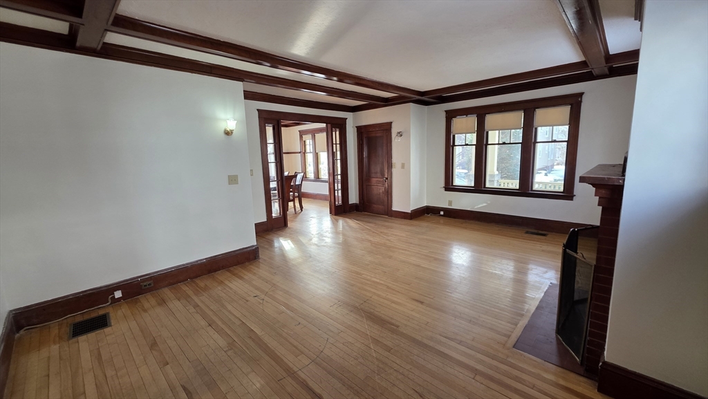 46 Wachusett Street Worcester, MA 01609 - Photo 12 of 42 an empty room with wooden floor and windows