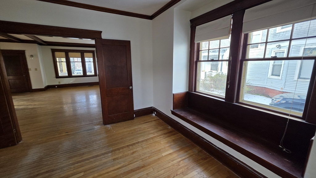 46 Wachusett Street Worcester, MA 01609 - Photo 14 of 42 a view of an empty room with wooden floor and a window