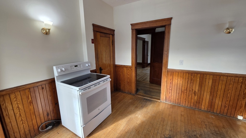 46 Wachusett Street Worcester, MA 01609 - Photo 17 of 42 a kitchen with a stove top oven and cabinets