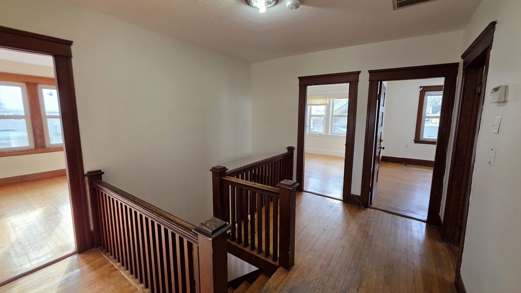 46 Wachusett Street Worcester, MA 01609 - Photo 22 of 42 a view of a hallway with wooden floor and staircase
