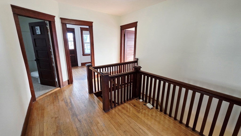 46 Wachusett Street Worcester, MA 01609 - Photo 23 of 42 a view of a hallway with wooden floor and staircase