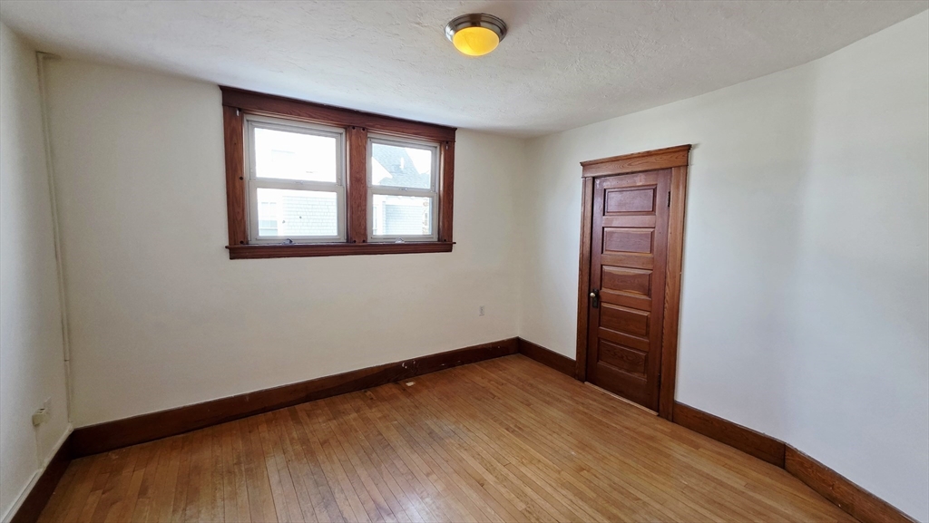 46 Wachusett Street Worcester, MA 01609 - Photo 24 of 42 wooden floor in an empty room with a window