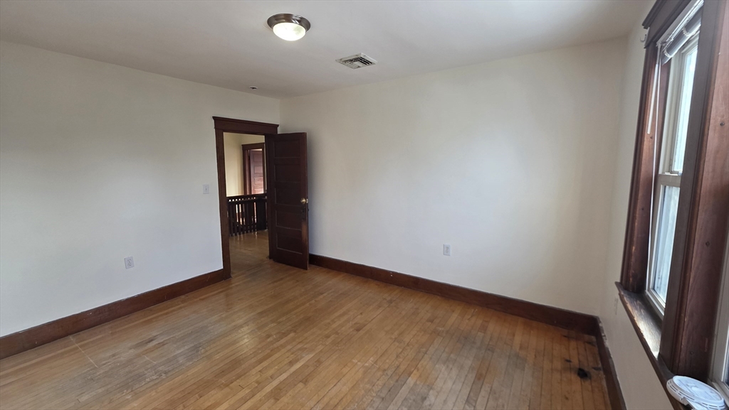 46 Wachusett Street Worcester, MA 01609 - Photo 26 of 42 a view of an empty room with wooden floor and a window