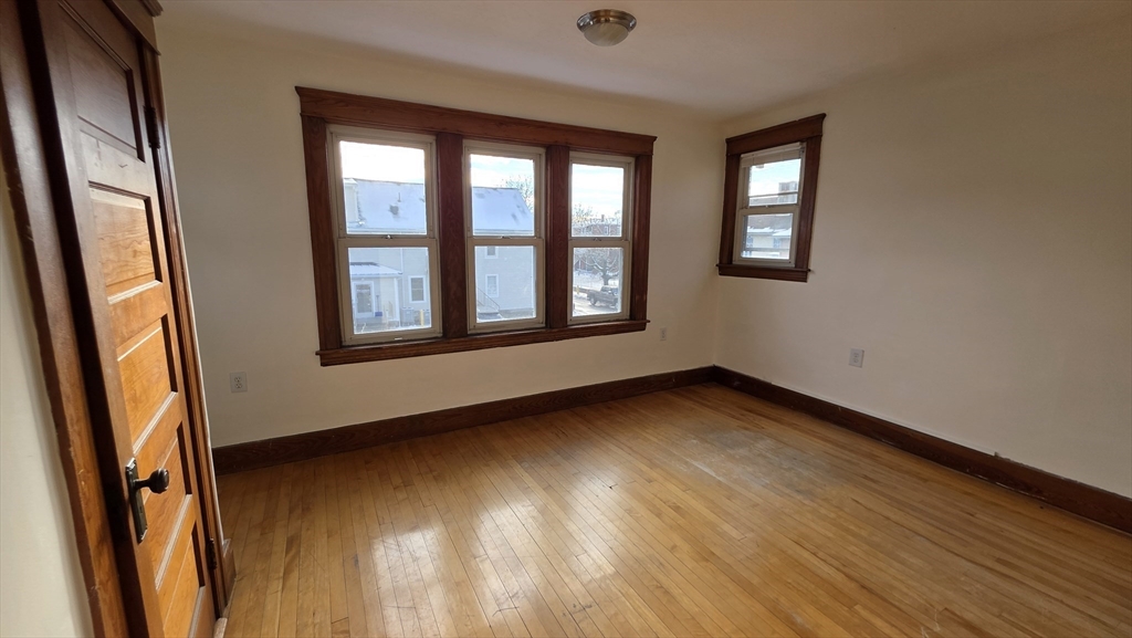 46 Wachusett Street Worcester, MA 01609 - Photo 31 of 42 a view of an empty room with a window and wooden floor