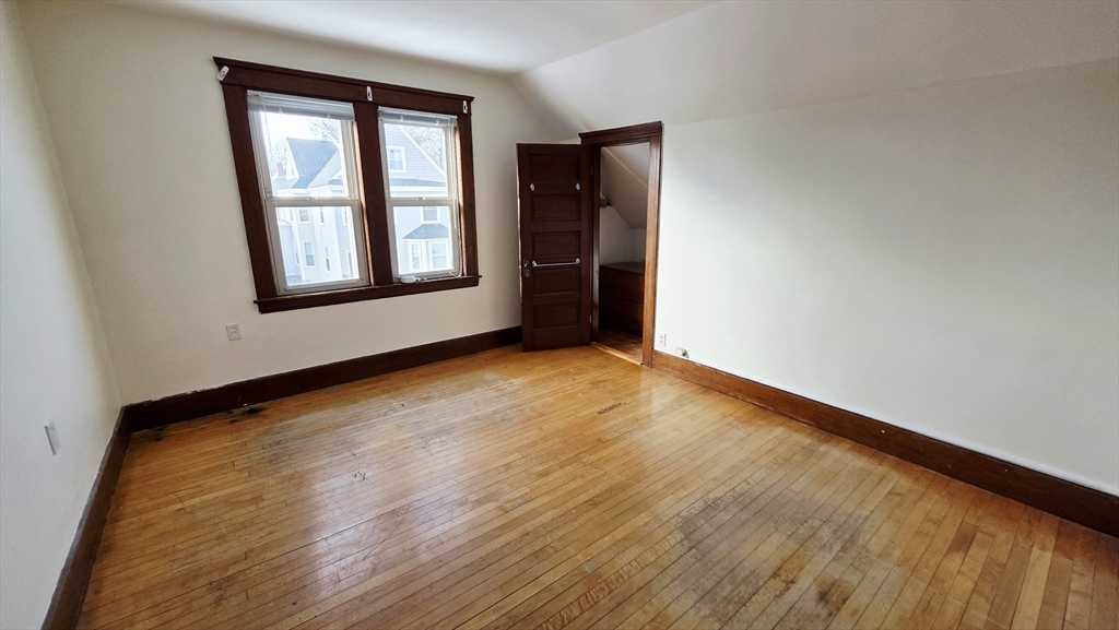 46 Wachusett Street Worcester, MA 01609 - Photo 33 of 42 an empty room with wooden floor and windows