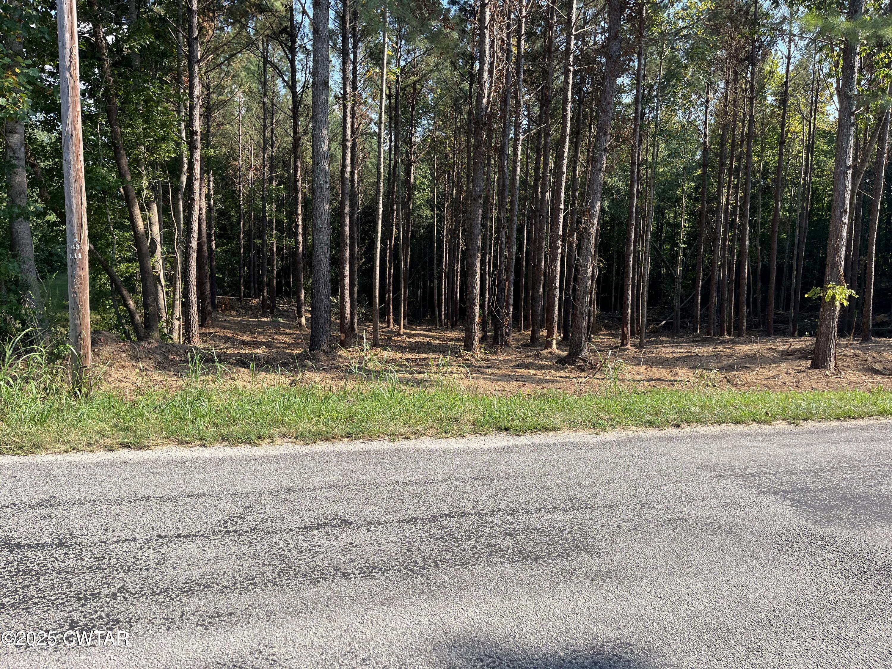a small white house with a yard and outdoor seating