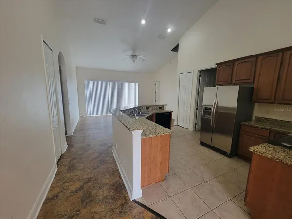 a kitchen with refrigerator and cabinets