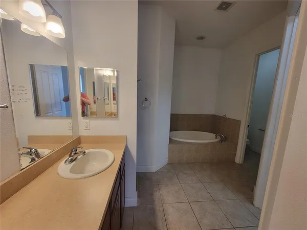 a bathroom with a sink toilet and a mirror