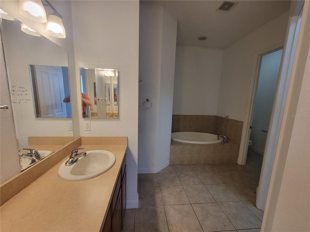 13092 Southwest 84th Terrace Road Ocala, FL 34473 - Photo 10 of 12 a bathroom with a sink toilet and a mirror