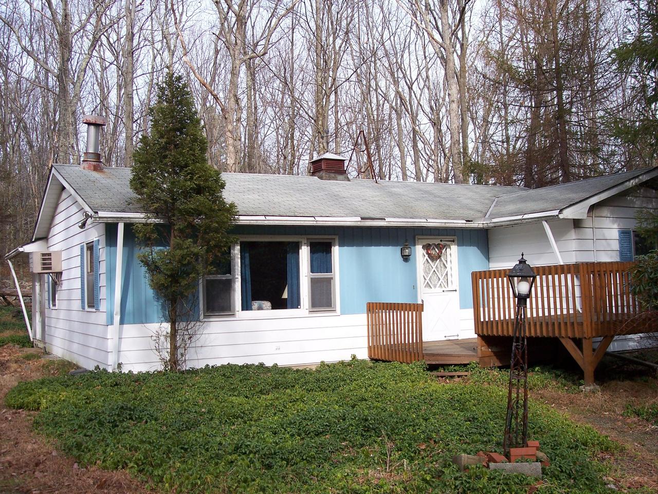 1 Spruce Cabin Road Cresco, PA 18326 - Photo 1 of 6 a view of a house with a yard