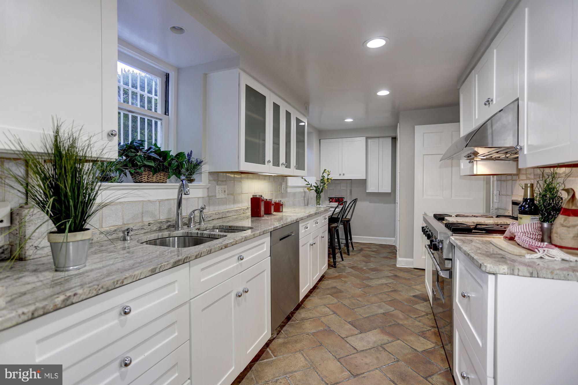3306 R Street Northwest Washington, DC 20007 - Photo 20 of 24 a kitchen with a sink stove and cabinets