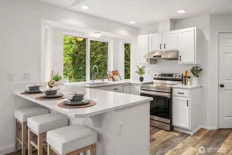 a kitchen with a sink stove and cabinets