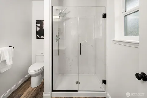 a bathroom with a toilet and a shower