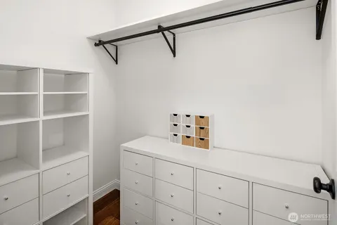 a room with a white cabinets and a wooden floor