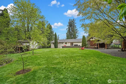 a view of a house with a backyard