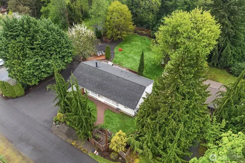 an aerial view of a house with a yard and outdoor seating