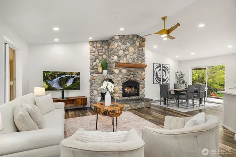 a living room with fireplace furniture and a fireplace