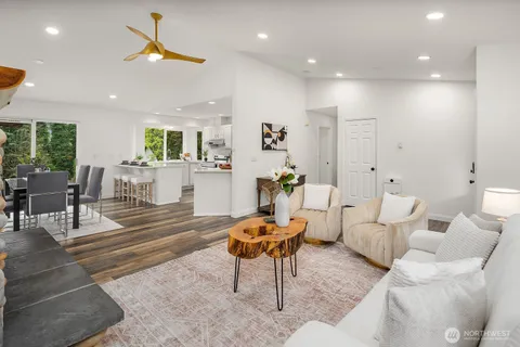 a living room with furniture and a chandelier