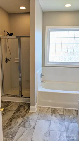 a bathroom with a glass shower door