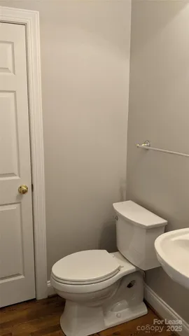 a white toilet sitting next to a bathroom sink