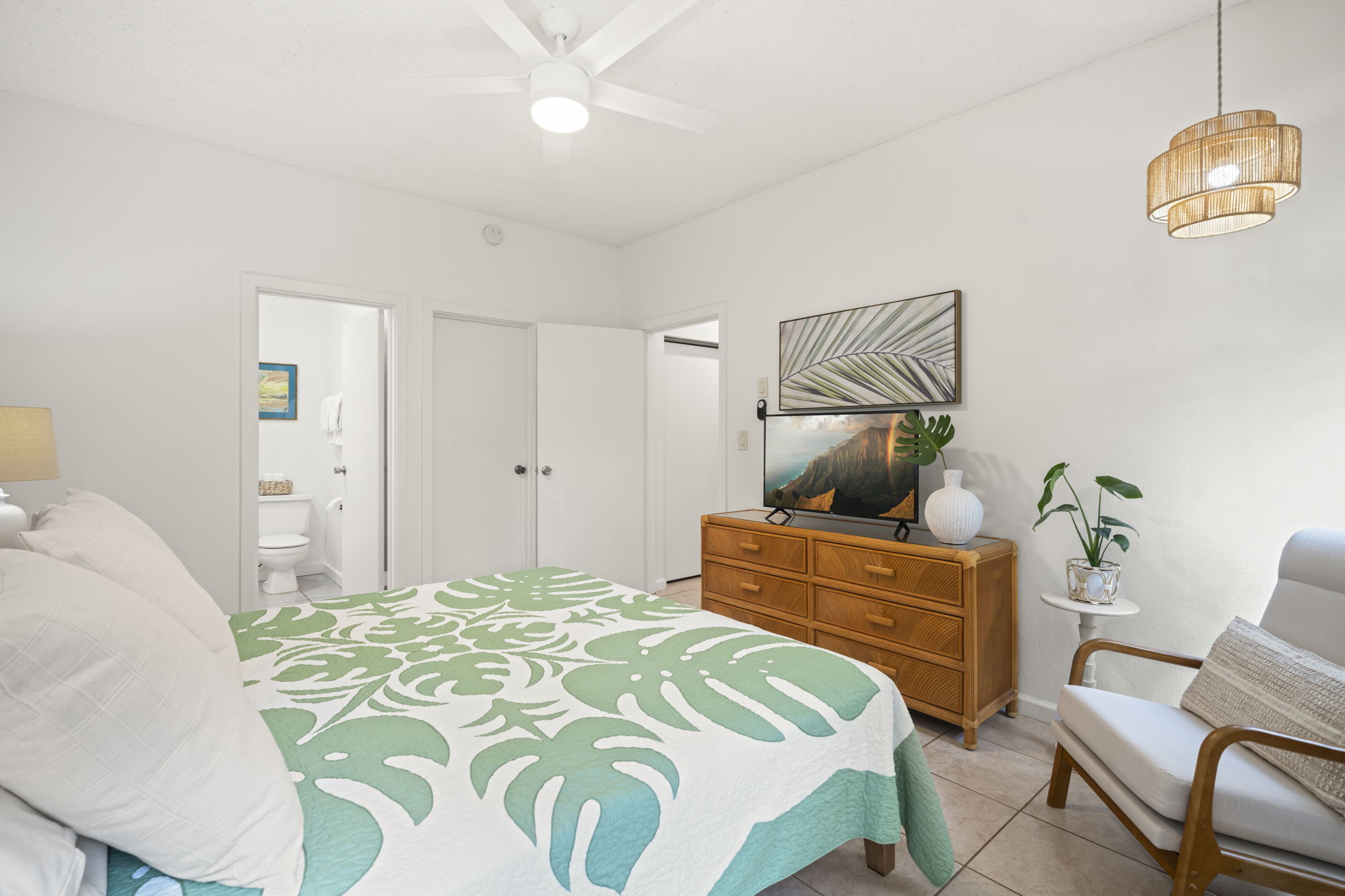 410 Papaloa Road, Unit 316 Kapaa, HI 96746 - Photo 18 of 30 a bedroom with a bed and a chandelier