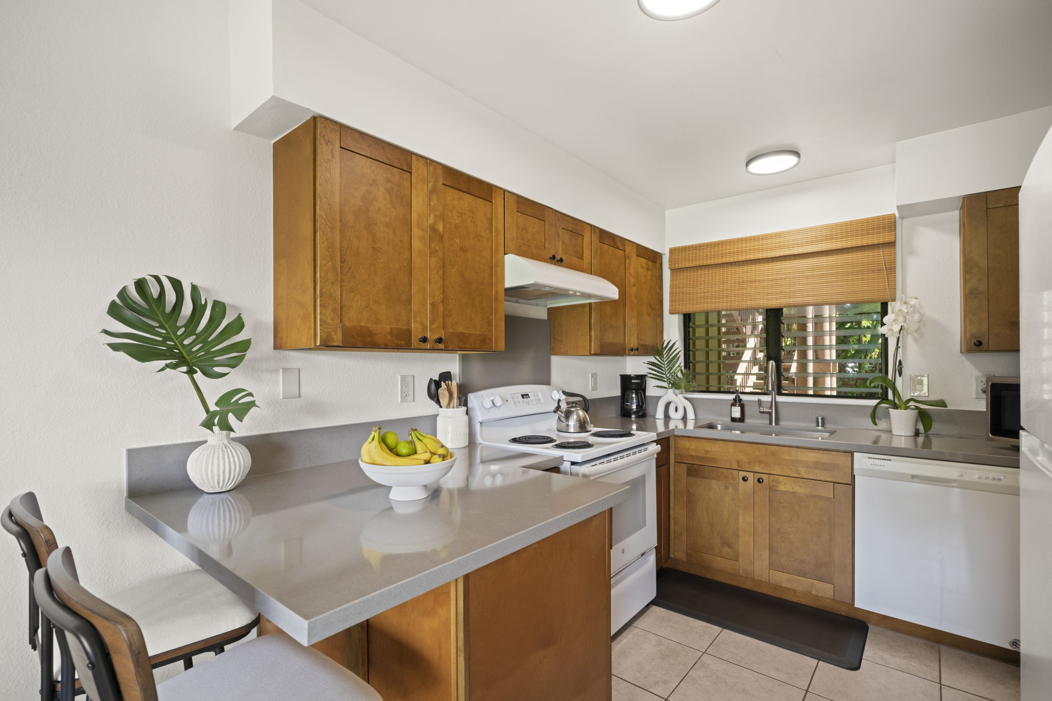 410 Papaloa Road, Unit 316 Kapaa, HI 96746 - Photo 10 of 30 a kitchen with a sink appliances and cabinets