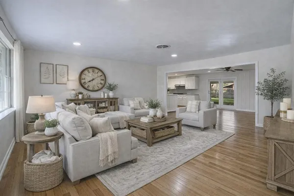 a living room with furniture and wooden floor