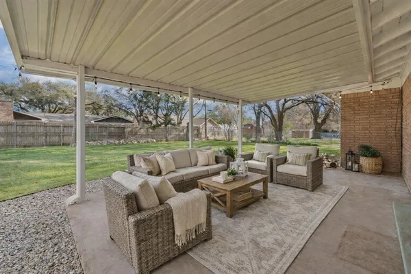 a patio with yard table and chairs
