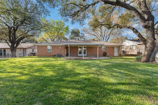a front view of house with yard and green space