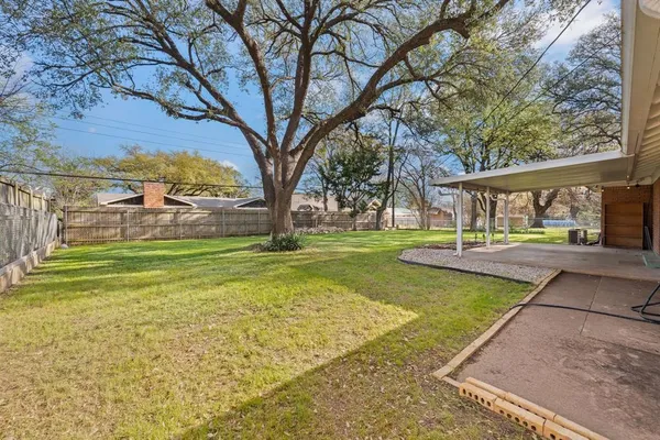 a view of yard with swimming pool and green space
