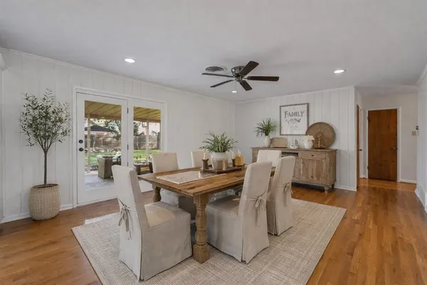 a view of a dining room with furniture and wooden floor