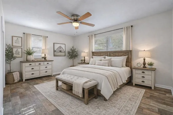 a spacious bedroom with a bed and a dresser