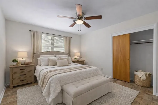 a bedroom with a large bed and a chandelier