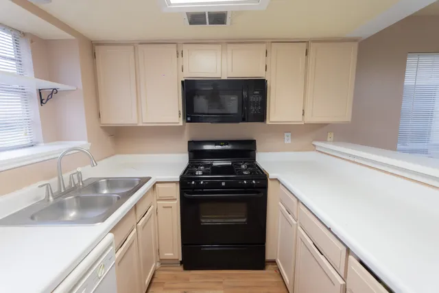 a kitchen with a sink stove and microwave