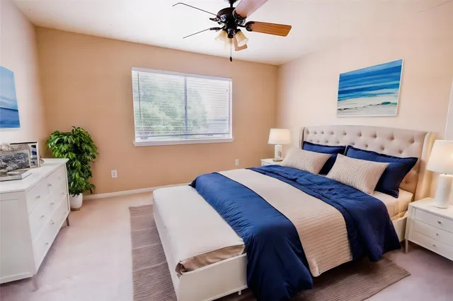 a bedroom with a large bed and a chandelier