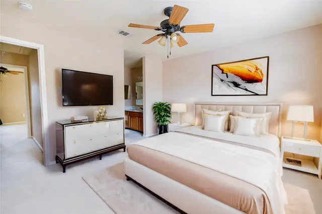 a bedroom with a bed and a flat screen tv