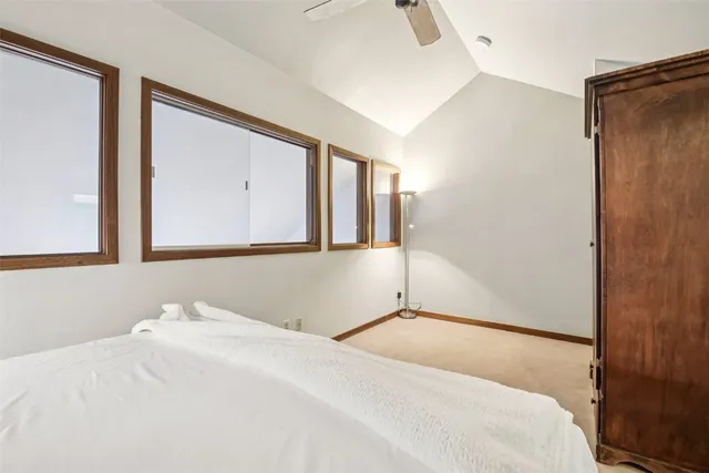 a bedroom with a bed and a large mirror