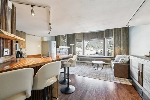 a living room with fireplace furniture and a large window