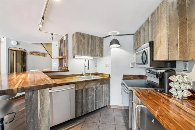 a kitchen with stainless steel appliances granite countertop a sink and a stove