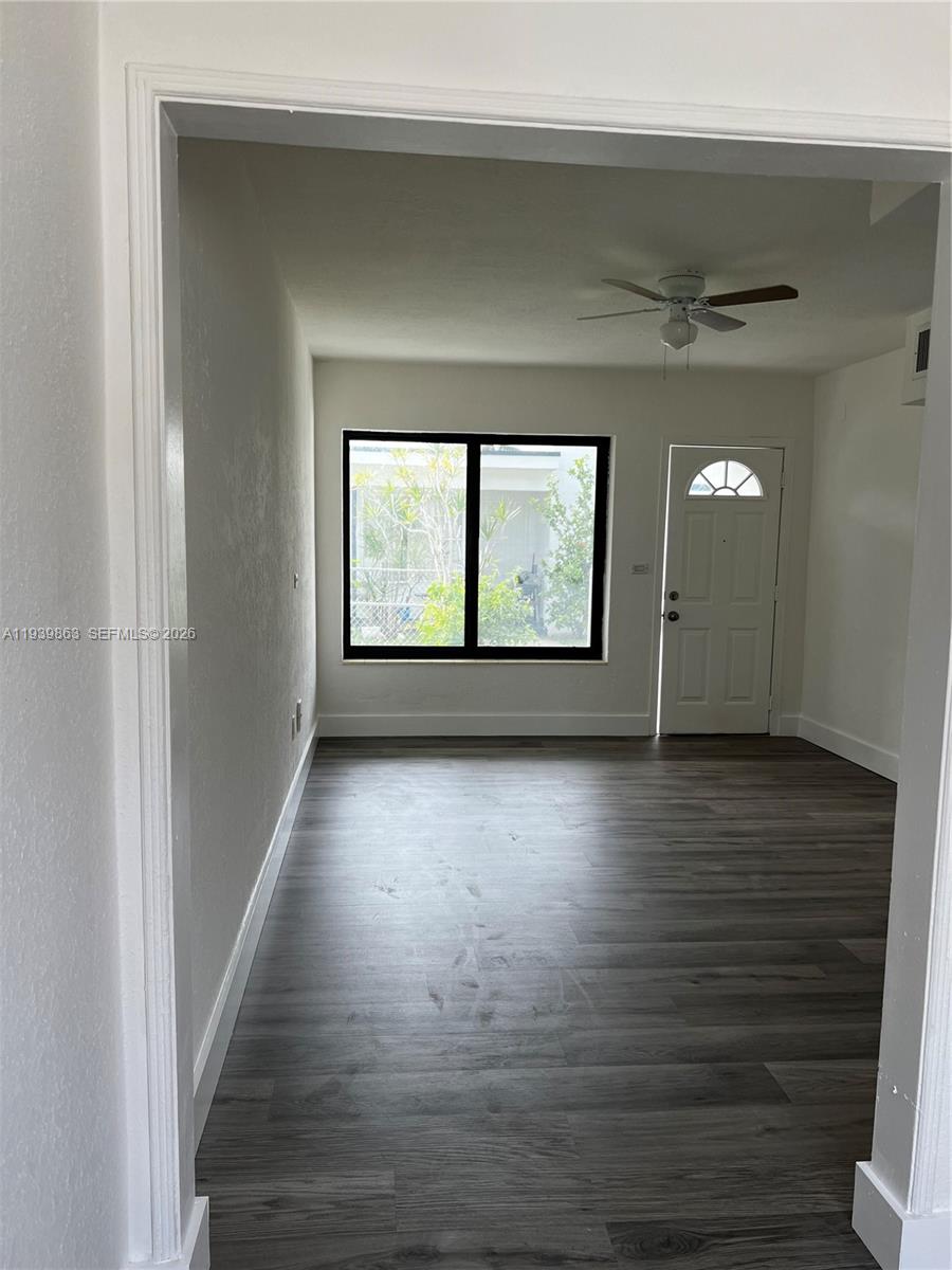 650 83rd Street, Unit 1 Miami Beach, FL 33141 - Photo 21 of 37 wooden floor in an empty room with a window
