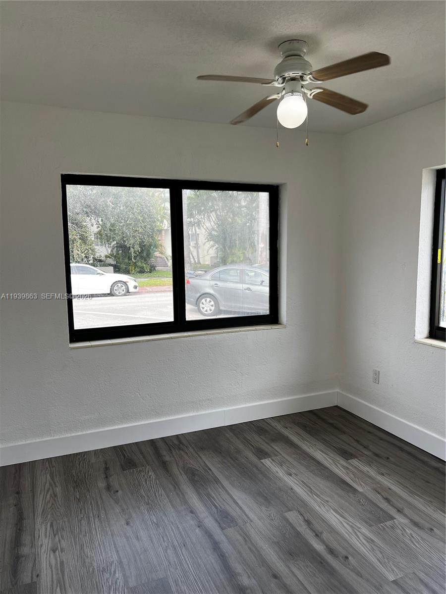 650 83rd Street, Unit 1 Miami Beach, FL 33141 - Photo 24 of 37 a view of empty room with wooden floor and fan