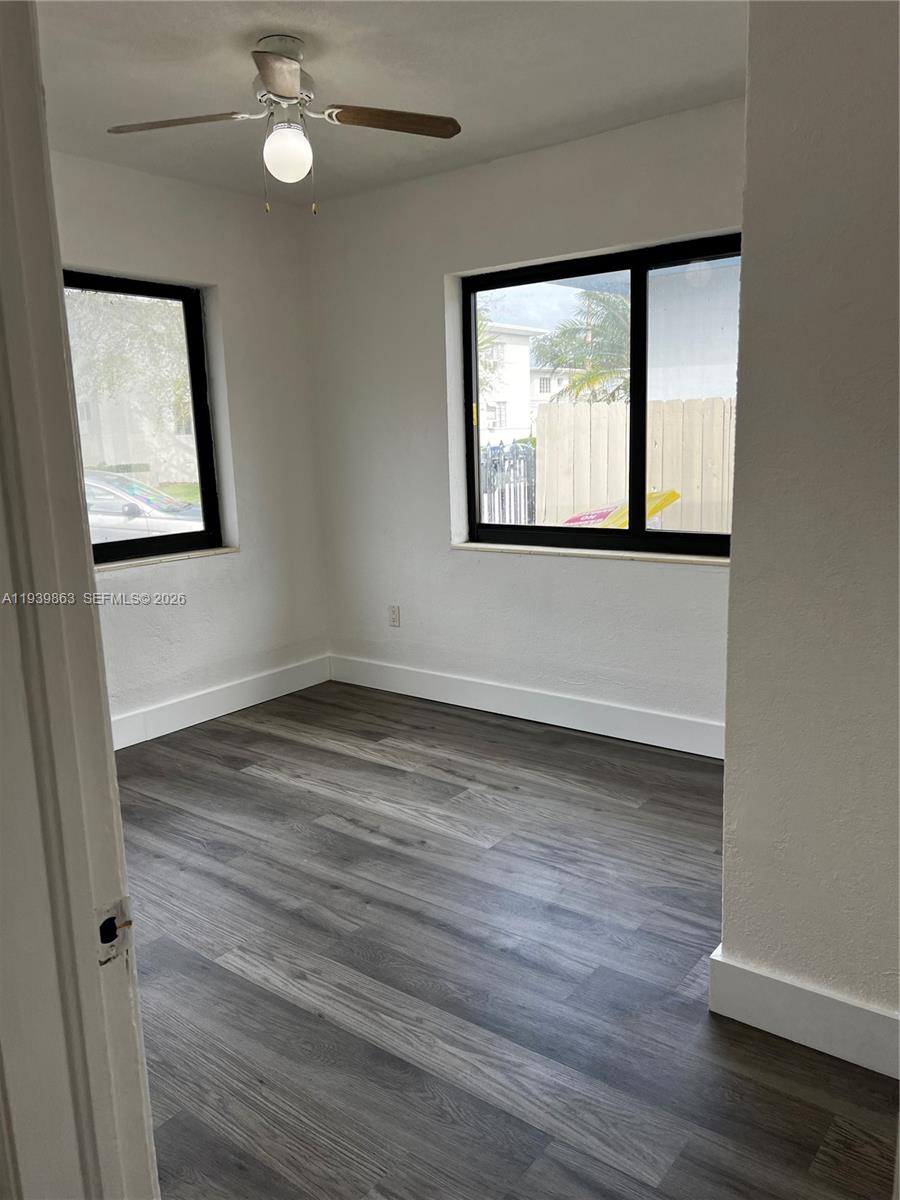 650 83rd Street, Unit 1 Miami Beach, FL 33141 - Photo 26 of 37 a view of an empty room with wooden floor and a window