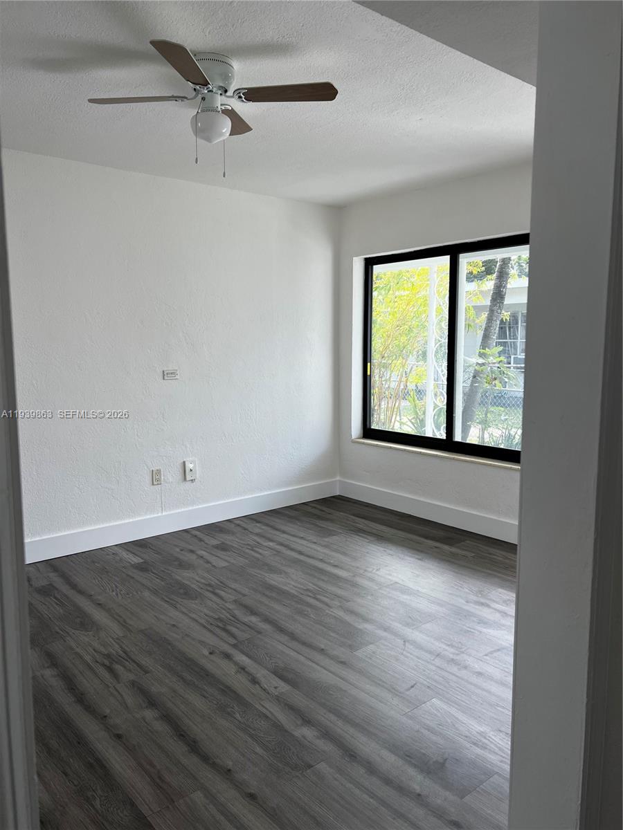 650 83rd Street, Unit 1 Miami Beach, FL 33141 - Photo 30 of 37 wooden floor in an empty room with a window