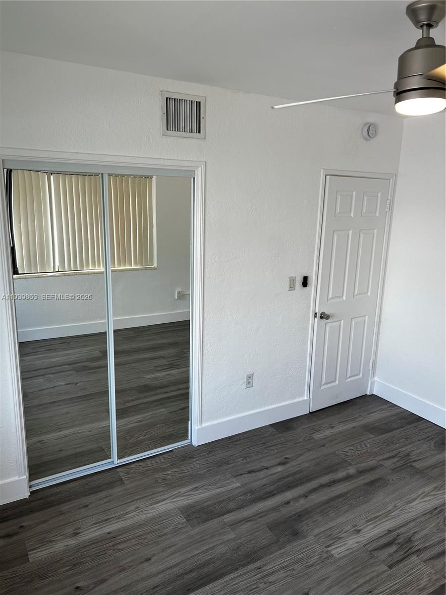 650 83rd Street, Unit 1 Miami Beach, FL 33141 - Photo 32 of 37 a view of an empty room with wooden floor and a window