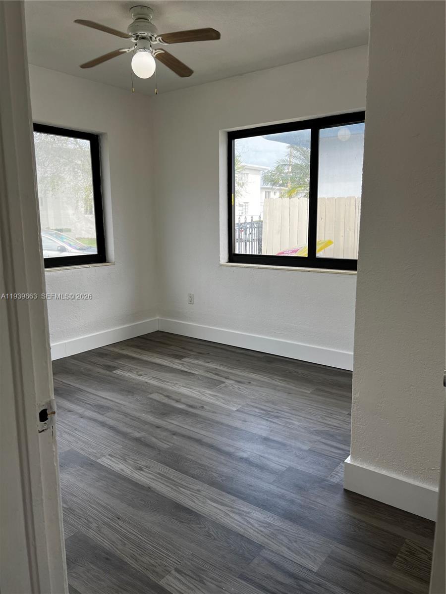 650 83rd Street, Unit 1 Miami Beach, FL 33141 - Photo 36 of 37 a view of an empty room with wooden floor and fan