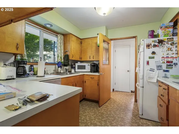 a kitchen with stainless steel appliances a sink and a large window